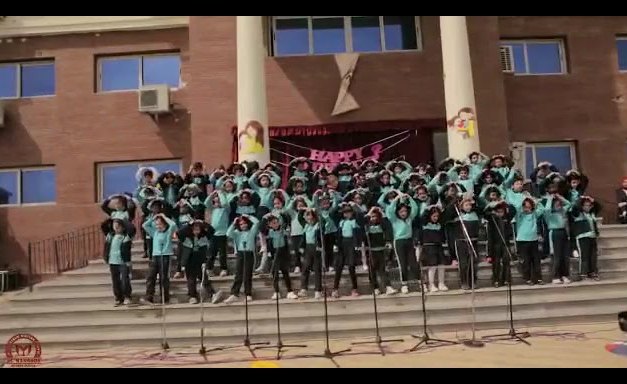 Students gathered in front of the Al Mansour Modern School building