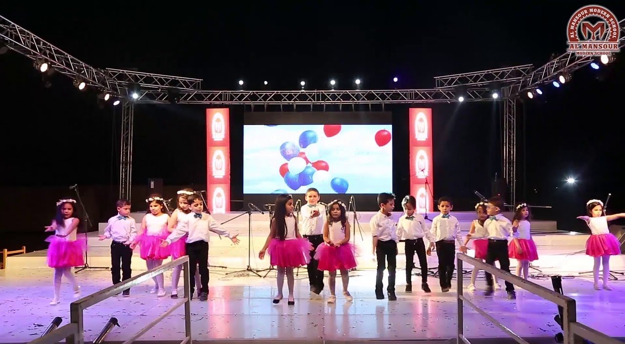 Pupils performing on stage at an Al Mansour Modern School event